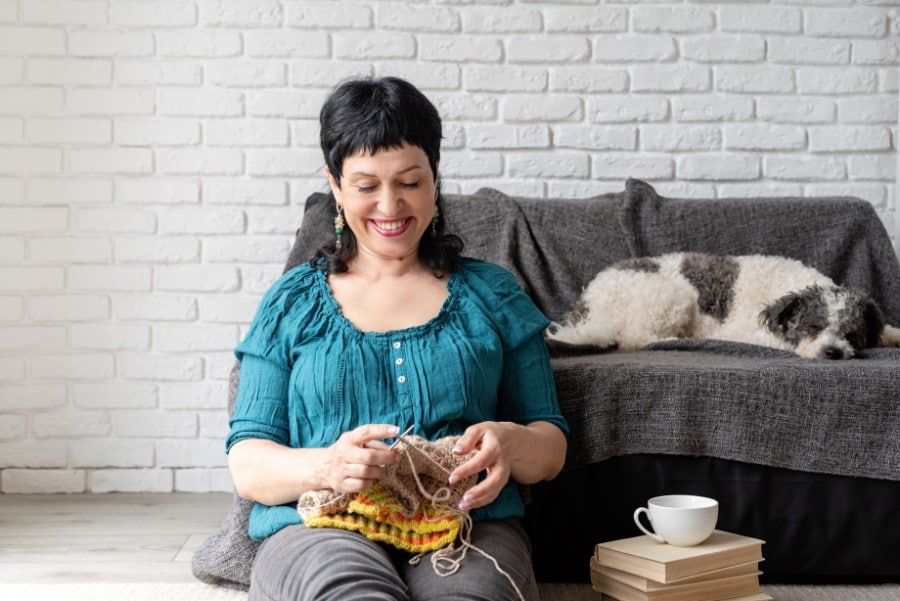 Bichon Frise and older woman knitting